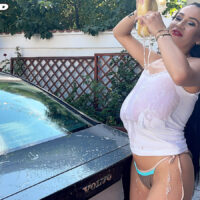 Skinny dark-haired girl frees her immense titties while getting moist during a car washing session