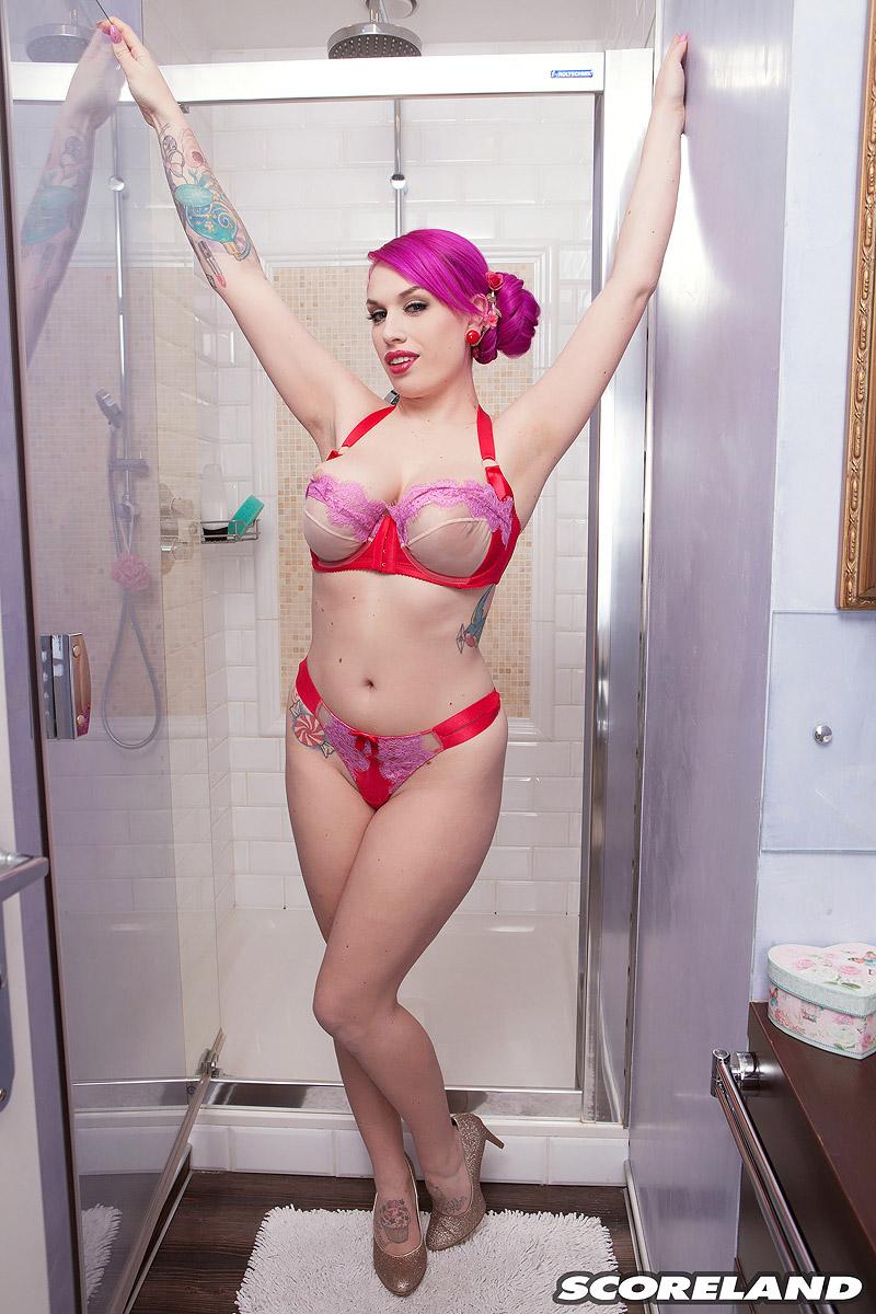 Solo female Lily Madison sports pinkish hair while soaping up her great titties in the shower