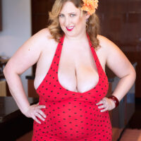 Redheaded BBW Amiee Roberts unleashes her big titties before licking a nipple