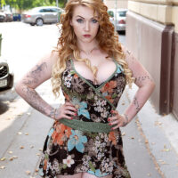 Tatted ginger-haired girl sets her monster-sized tits loose of a dress and hooter-slings in a g-string