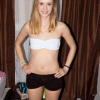 Skinny teen Rachel James tugs on a massive dick after being rendered naked