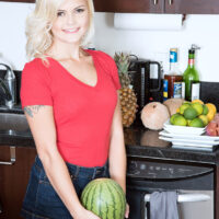 Blonde nubile Madison Hart stands naked after getting rid of her clothes while in a kitchen