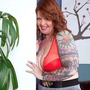 Tattooed BIG HOT WOMAN with crimson hair and gigantic boobs Vanya Vixen fellates a fake penis after disrobing