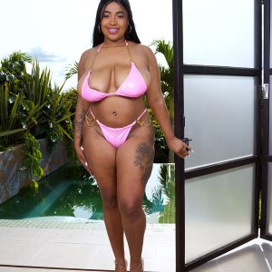 Thick Latina girl Thayana oils up her large breasts after peeling off her bikini top
