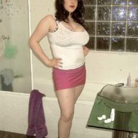 Dark-haired MILF Angela Milky modelling non au naturel in mini-skirt and in bathroom and kitchen